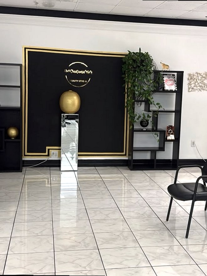 Reception of Hair Creations M&M with the black and gold wall, Naples FL hair salon