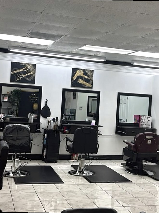 Styling stations with mirrors and black chairs at Hair Creations M&M, Naples FL